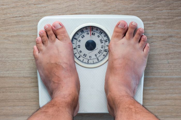 man's feet on a scale