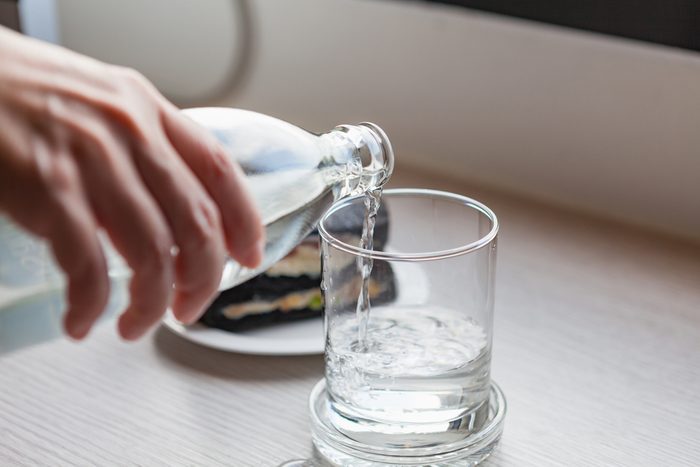 pouring water into glass