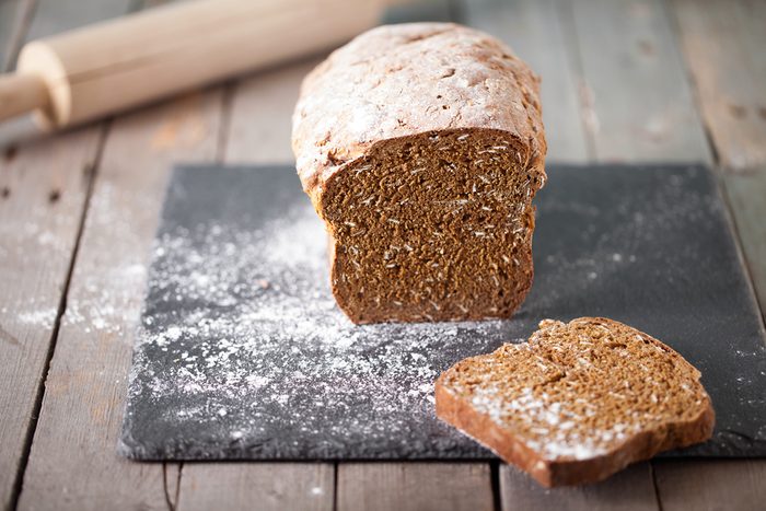 Fresh Irish soda bread with oat sliced on a slate cutting board.