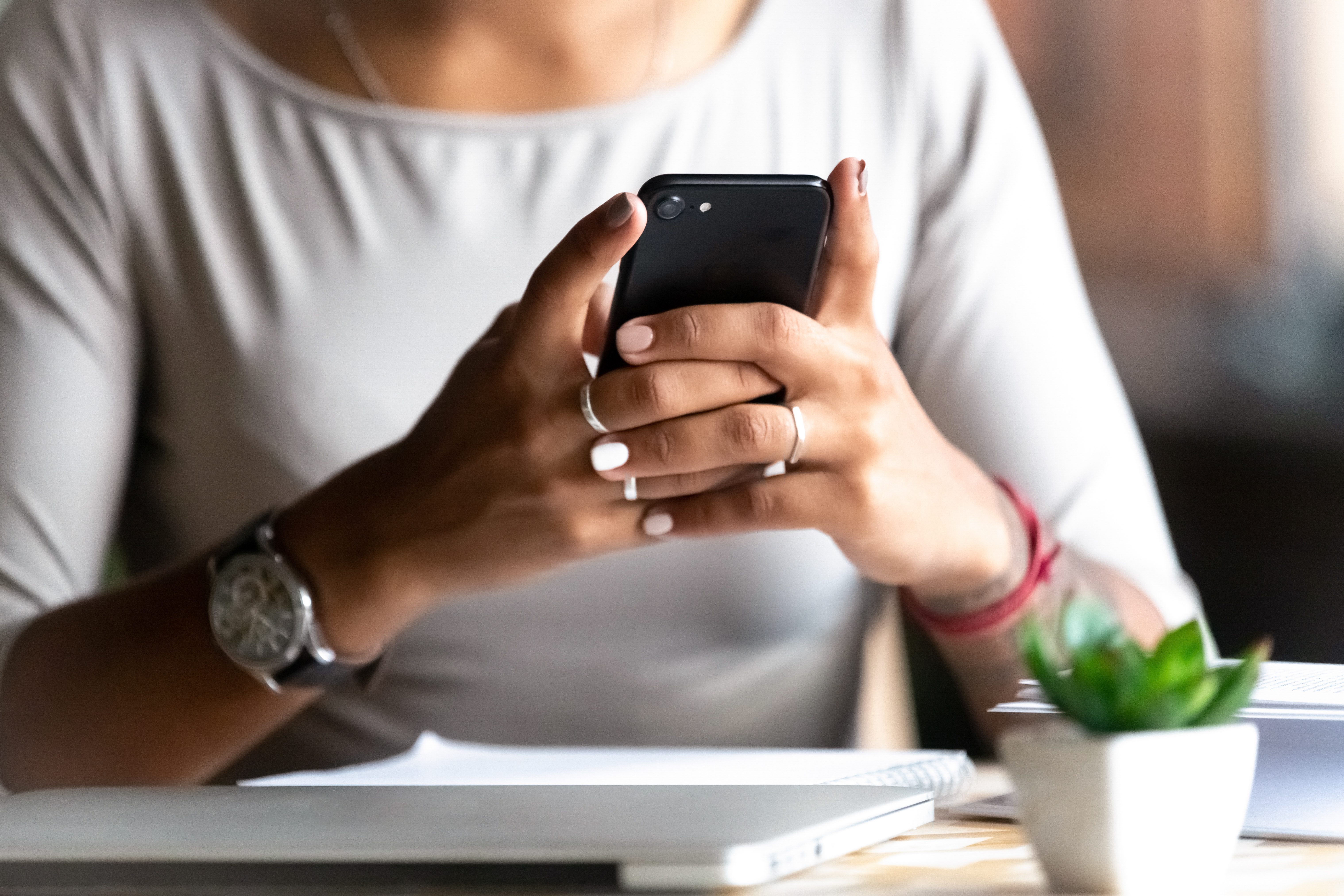 Close up woman holding smartphone, typing message, texting, chatting, female hands using cellphone, browsing mobile apps, internet, checking social networks, email, playing games on phone