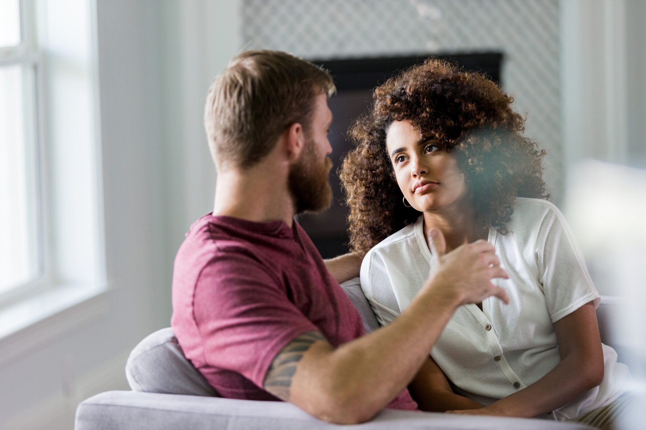 Mid adult woman listens seriously to husband's ideas
