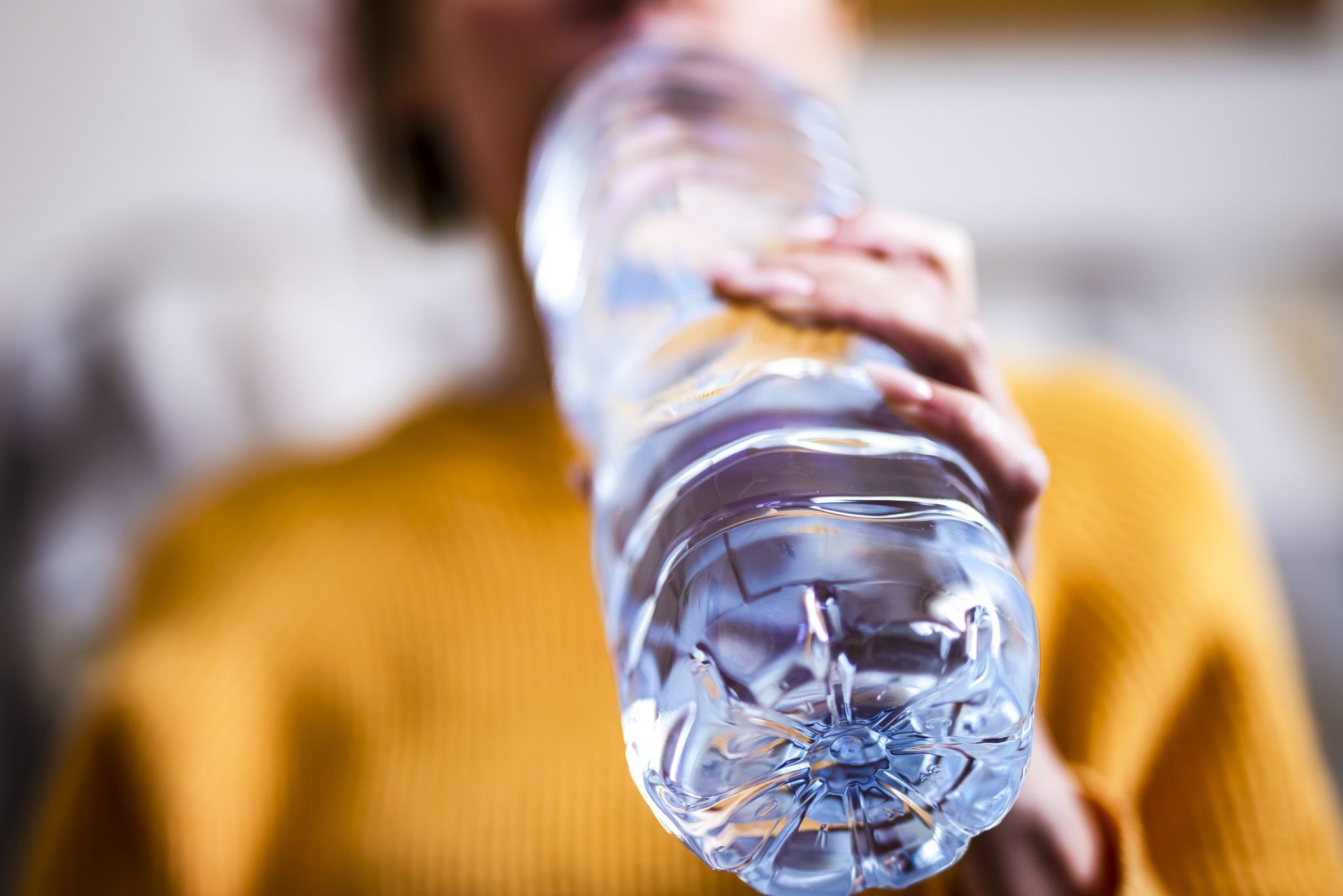 Woman drinking mineral water from the bottle