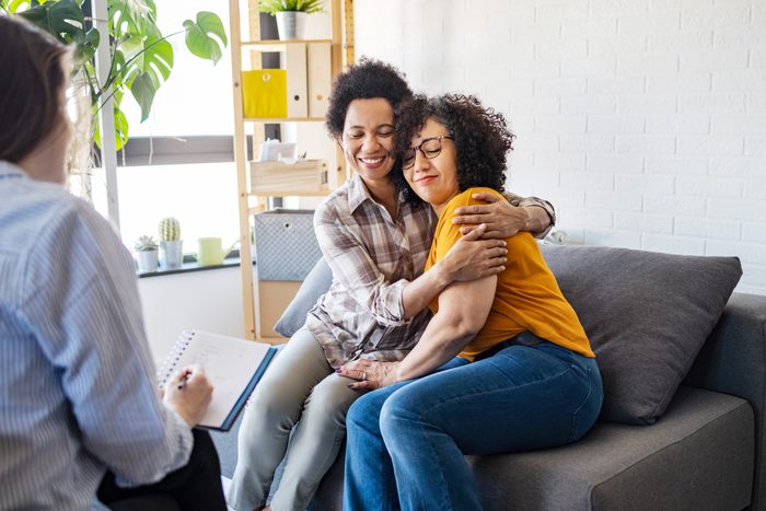 Lesbian couple embracing during relationship counseling