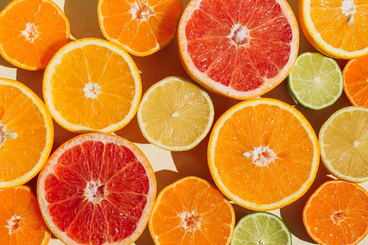 Pattern Of Slices Citrus Fruit Of Lemons Oranges Grapefruit And Lime On Beige Background